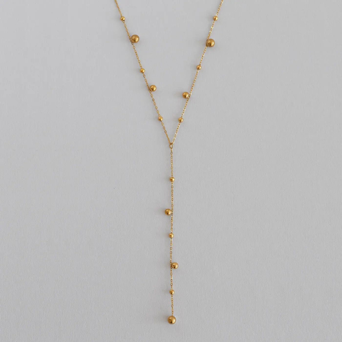 Klara - Collana Lariat con punti dorati in acciaio inossidabile